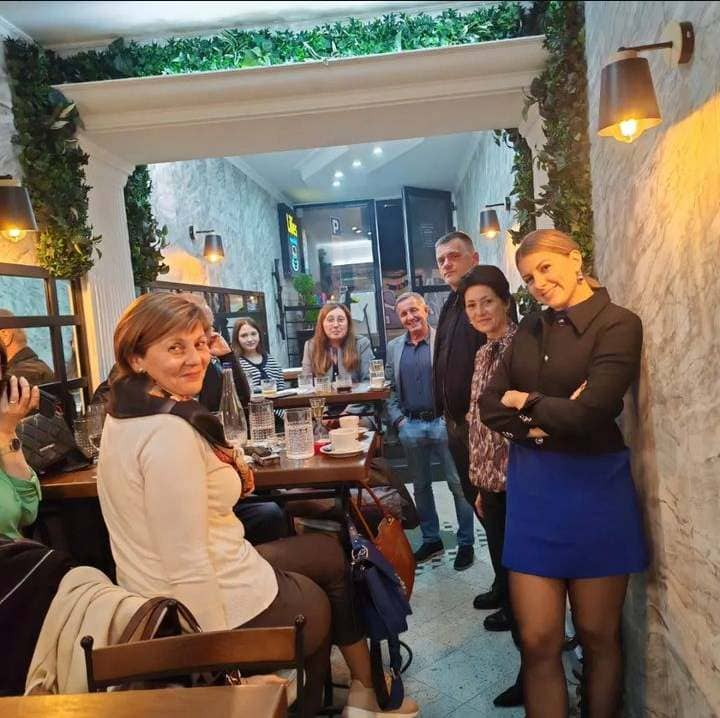 Group of friends enjoying a gathering at Lillies Cafe in Belgrade, sharing laughs and drinks.