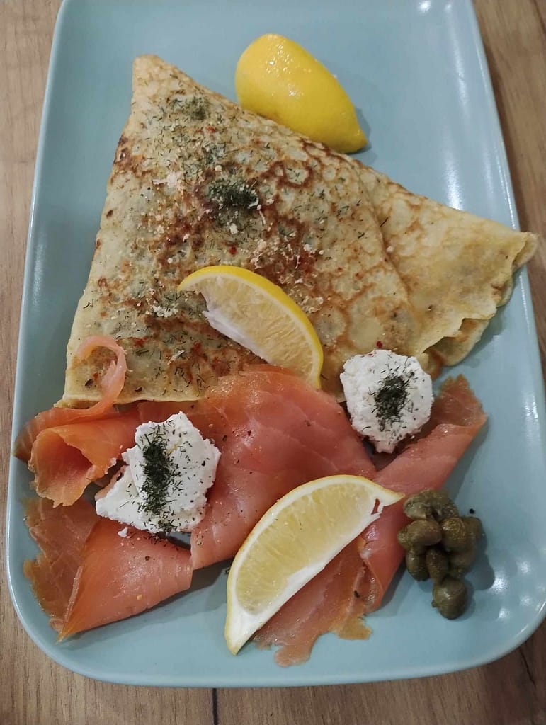 Savory salmon crepe with smoked salmon, kaymak, and fresh herbs at Lillies Cafe.